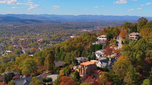 Private mountain homes surrounded by brilliant fall colors. Dense forest blankets the rolling hills around peaceful residential community.
