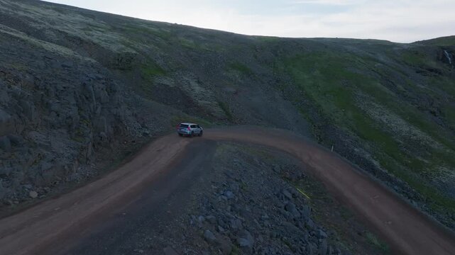 Smooth tracking flight of mountain switchback and rugged landscape in Iceland