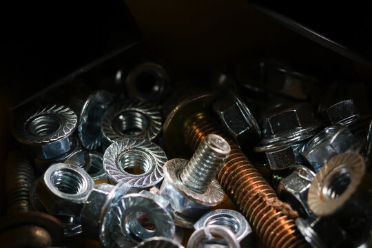 Metal nut metal bolt threaded fastener hardware metal screw close up industrial mechanical part metal object tool metallic construction repair machinery steel silver shiny textured spiral