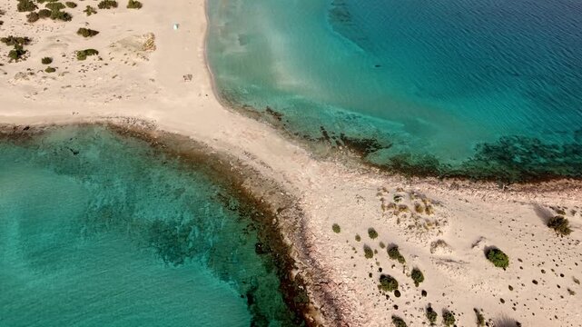 Simos beach double bay divided by a narrow, sandy strip of land, Aegean Sea, Drone shot