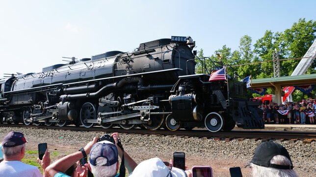 Pottstown, Pennsylvania, U.S.A - Jul 2, 2026 - Union Pacific Big Boy 4014 passing crowds photographing the locomotive near a decorated station platform.