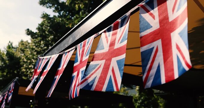 Details with the United Kingdom flags waving in the wind during a UK national celebration.