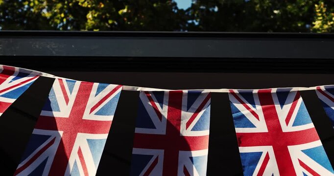 Details with the United Kingdom flags waving in the wind during a UK national celebration.