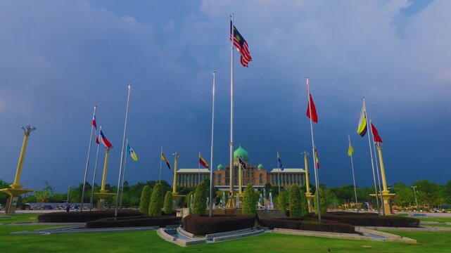 Malaysian national flag and state flags waving at Putra Square with Prime Minister office background