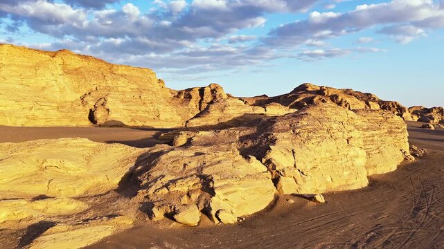 Sunset over majestic yardang landform with red rock formations in Xinjiang, China.