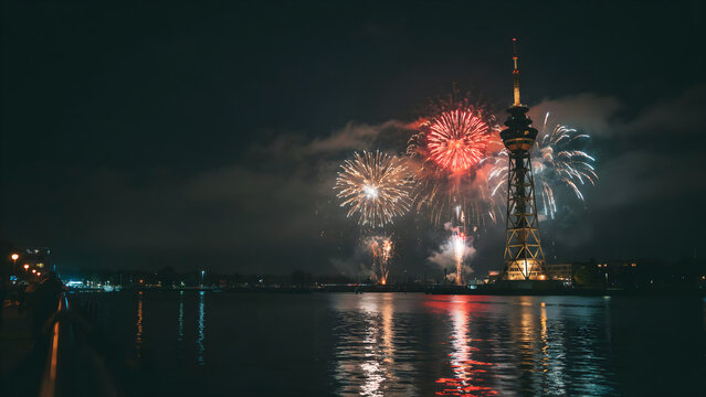 Fireworks exploding over calm water at night