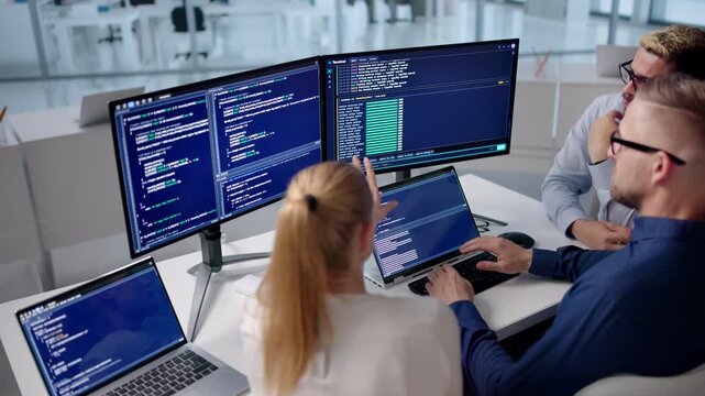 Software Engineers Collaborate Closely At Desk
