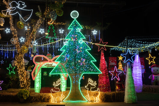 Colorful Christmas light display with glowing Christmas tree and festive holiday decorations at night