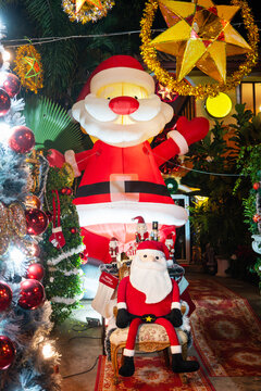 Festive Santa Claus Christmas display with glowing holiday decorations and illuminated Christmas lights at night