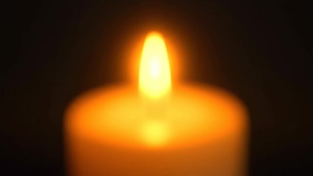 Lit Candle with Warm Glow in Dark Background, Peaceful Ambiance