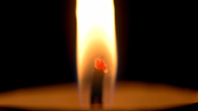 Candle Flame Burning Brightly in Dark Environment with Warm Glow
