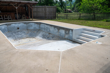 Empty Residential Swimming Pool Under Repair with Vinyl Liner Removed Steel Exposed, Steps