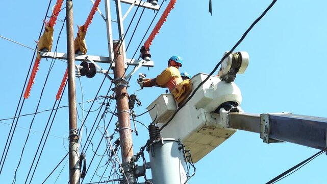 Utility Crew Performing Live Line Connection on Single-Phase Distribution Transformer from Bucket Truck