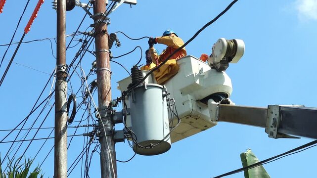 Electrical Utility Workers Performing Single Phase Distribution Transformer Maintenance with Full Safety Equipment
