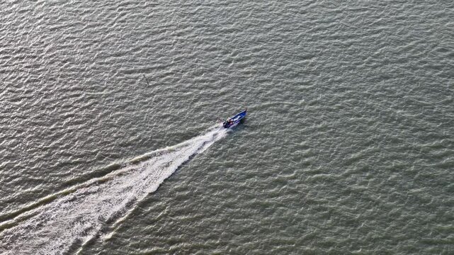 Aerial drone view of fisherman boat moving at sea