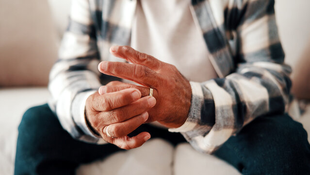 Hands, ring and thinking with old man on sofa in home living for grief, loss or pain as widower. Lonely, reflection and sad senior person with depression in apartment for relationship nostalgia