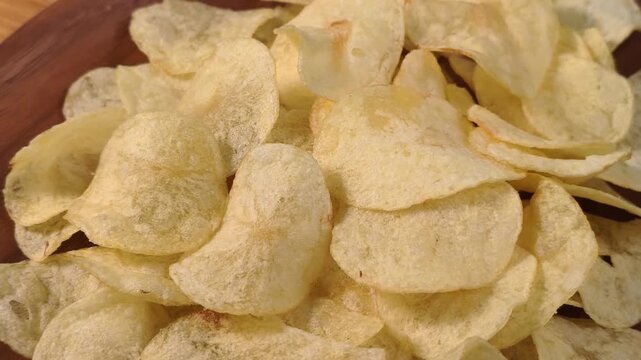 A pile of thin, crispy, golden potato chips