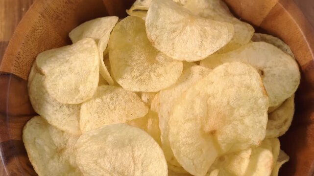 A pile of thin, crispy, golden potato chips