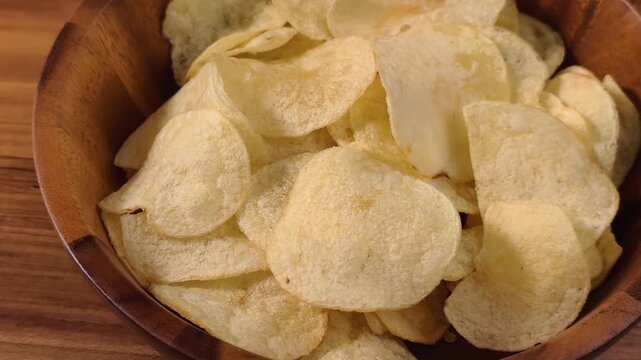A pile of thin, crispy, golden potato chips