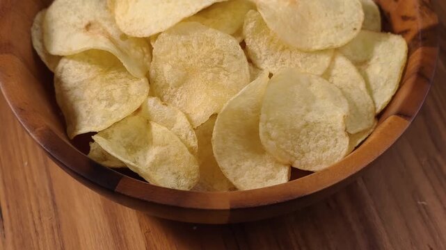 A pile of thin, crispy, golden potato chips