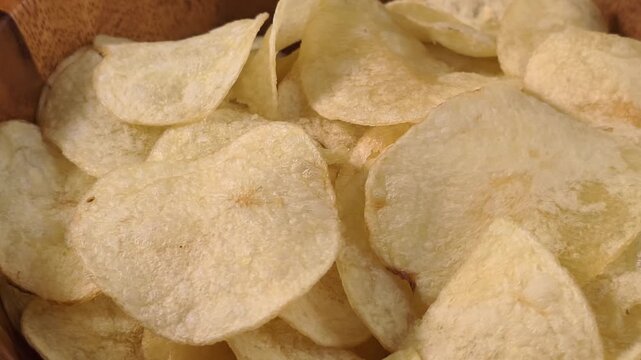 A pile of thin, crispy, golden potato chips