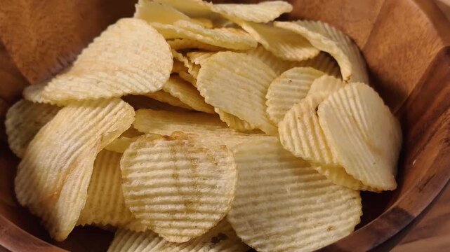 A pile of wavy, ridged potato chips up close