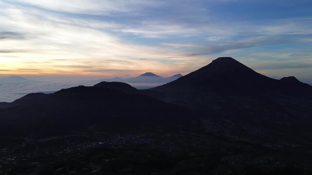 Aerial Drone View of Sunrise Between Mountain Ranges with Peaceful Morning Landscape