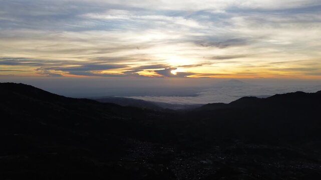 Aerial Drone View of Sunrise Between Mountain Ranges with Peaceful Morning Landscape
