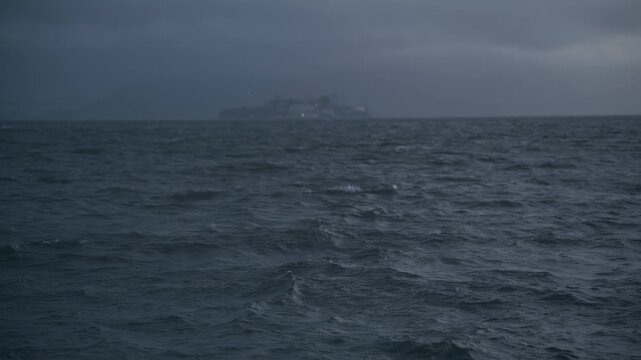San Francisco Bay With View Of Alcatraz Island Across Rough Swell On Dark, Overcast Sky