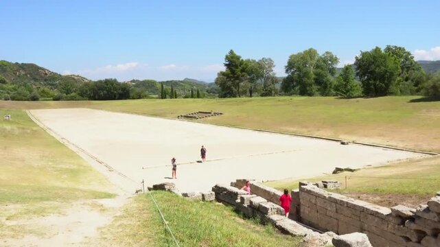 People visiting the ancient stadium of Olympia in Greece