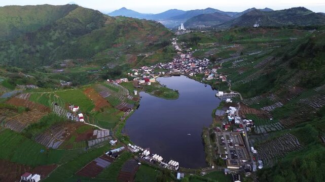 Aerial drone footage of the tranquil Telaga Cebong during dawn in the Dieng Plateau, Central Java, Indonesia. 