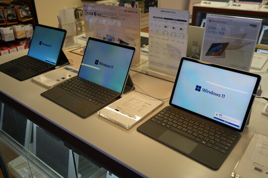 Microsoft Surface laptops displayed on a retail store counter.