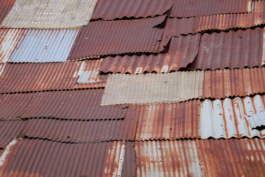 Artistic of old and rusty zinc sheet wall. Vintage style metal sheet roof texture. Pattern of old metal sheet. Rusting metal or siding. Corrosion of galvanized. Background and texture in retro concept