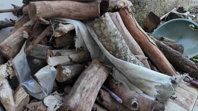a messy pile of cut logs and discarded debris.