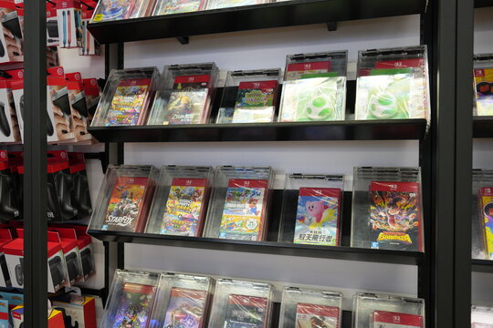 Nintendo Switch video game boxes displayed on a retail store shelf.