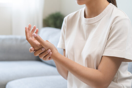 Health care and medical concept, rheumatism asian woman hand pain from cramp, trigger finger, wrist pain touching massaging, hand holding ache joint, arthritis inflammation.Chronic disease from injury