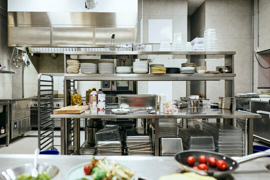 Interior view of empty commercial kitchen with stainless steel counters