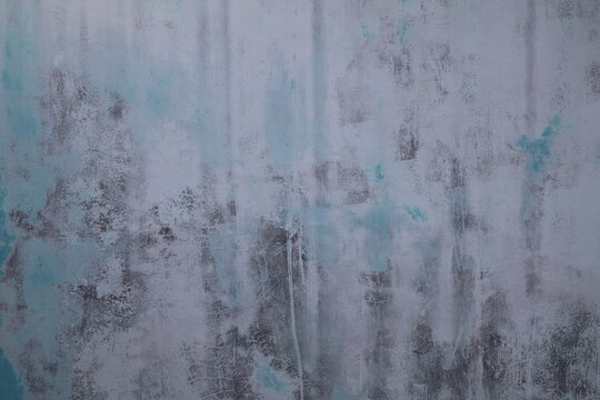 Blue wall gradually fading from weather exposure, retaining smooth texture and structural integrity throughout.