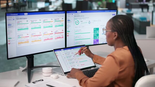 Business Executive Reviews Quarterly OKR Progress On Laptop