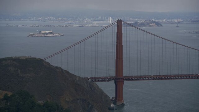 Golden Gate Bridge South Tower With View Of Alcatraz Island On Stormy Day - Aerial Shot
