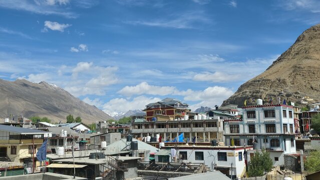 Kaza town spreads beneath rugged mountains, surrounded by hotels, homes, and dramatic Himalayan landscapes.