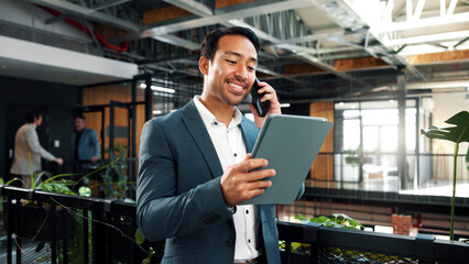 Fototapeta premium Happy, phone call and businessman with tablet in office, wealth management and chatting with contact. Business, financial advisor and person with mobile for communication, online or investment update