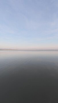 Calm Water Reflecting Sky