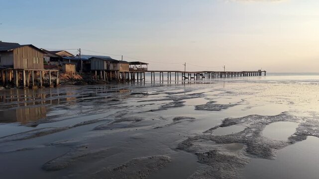 Seaside stilt houses and wooden pier at Segenting Batu Pahat