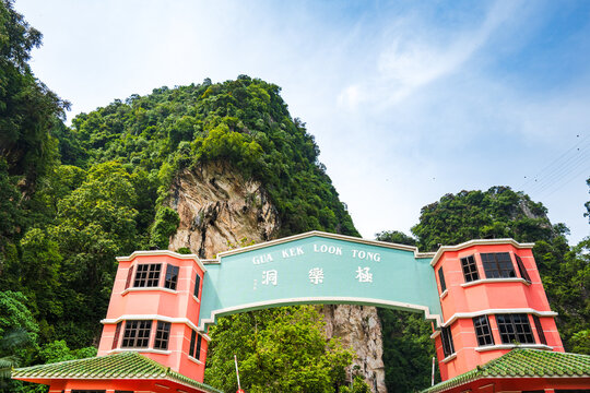 Ipoh, Malaysia - July 1, 2026: Gua Kek Look Tong cave temple entrance gate with limestone karst hill, Ipoh, Malaysia.