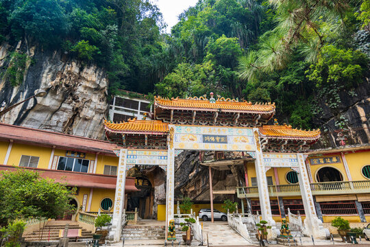 Ipoh, Malaysia - July 1, 2026: Sam Poh Tong cave temple entrance with ornate gate and limestone cliff, Ipoh, Malaysia.