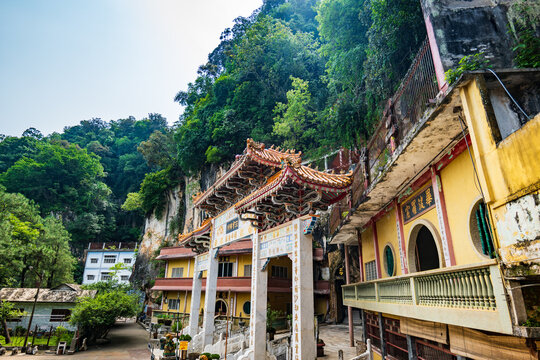 Ipoh, Malaysia - July 1, 2026: Sam Poh Tong cave temple entrance with ornate gate and limestone cliff, Ipoh, Malaysia.
