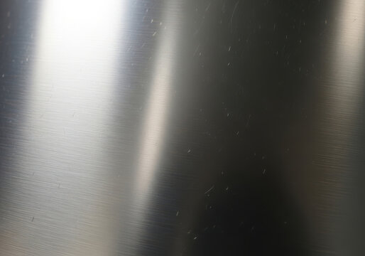 A close up view of a brushed stainless steel surface with light surface scratches