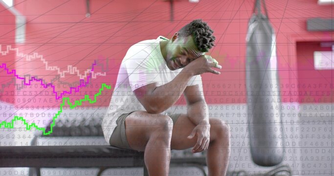 Recovering after set, man in white T-shirt, gray shorts wiping sweat on gym bench, data overlay
