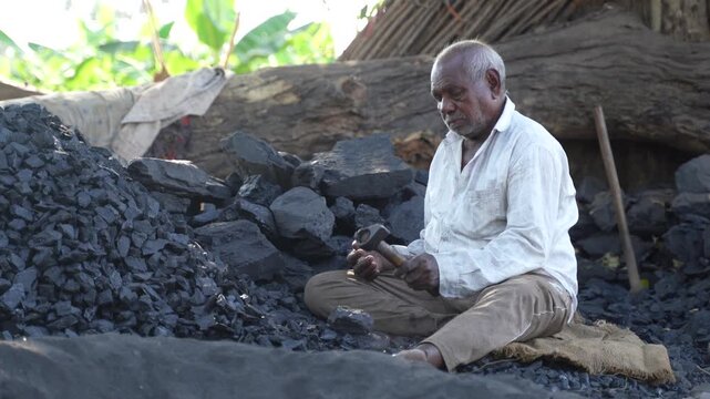 Indian senior man working at bricks factory